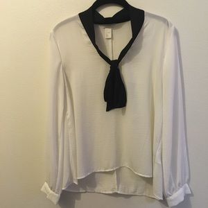 White long sleeved blouse with black tie